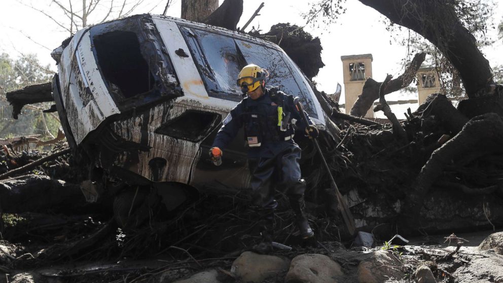 PHOTO: A member of the Los Angeles County Fire Department Search and Rescue crew works near a car trapped under debris in Montecito, Calif., Jan. 10, 2018.