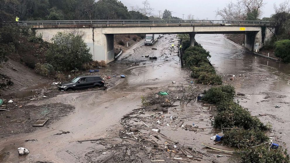 PHOTO: US 101 Freeway at the Olive Mill Road overpass flooded with runoff water from Montecito Creek and blocked with mudflow and debris following heavy rains in Montecito, Calif., Jan. 9, 2018. 