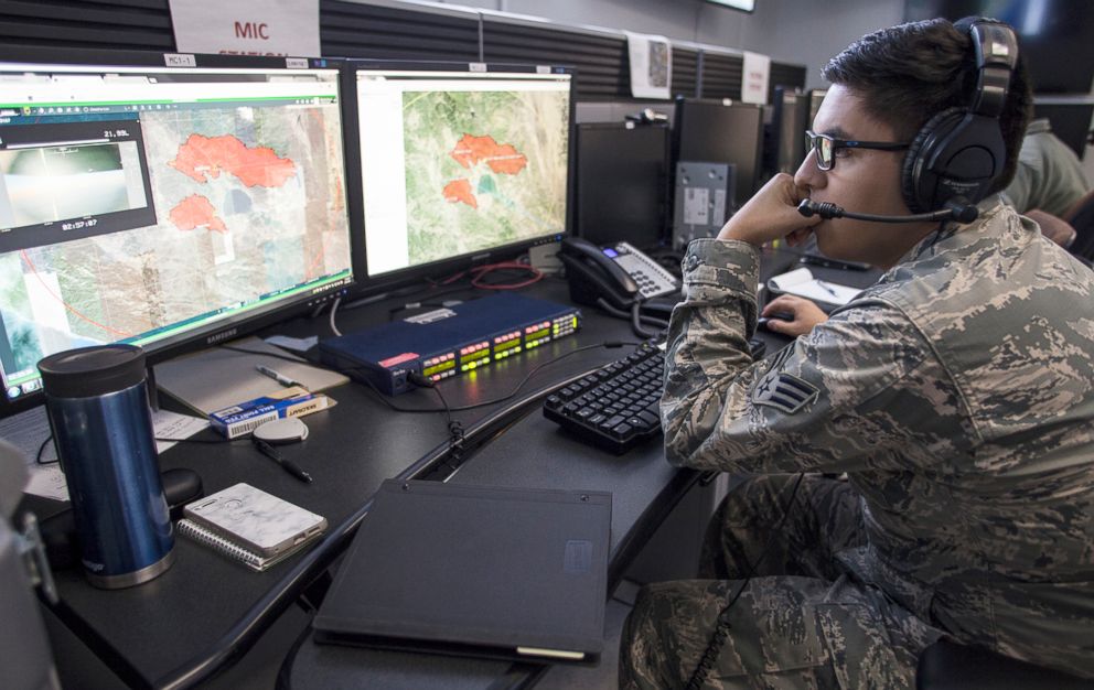 PHOTO: U.S.A.F. Senior Airman Michael Chacon of the 163d Operations Support Squadron/California Air National Guard, looks at a fire map for the Mendocino Complex Fire, Aug. 4, 2018, while working in an operations center at March Air Reserve Base, Calif. 