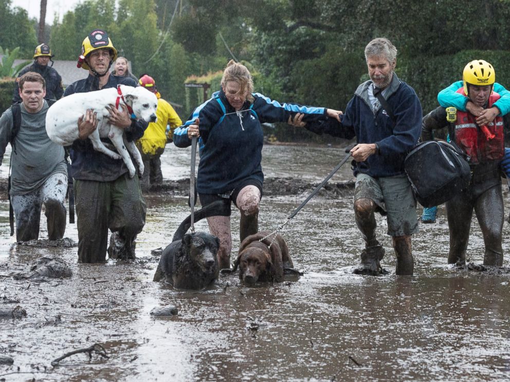 PHOTO: Emergency personnel evacuate local residents and their dogs after a mudslide in Montecito, Calif., Jan. 9, 2018.