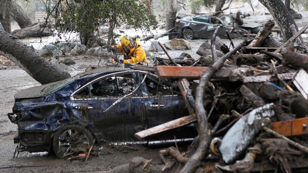 PHOTO: A member of the Long Beach Search and Rescue team looks for survivors in a car in Montecito, Calif., Jan. 9, 2018.