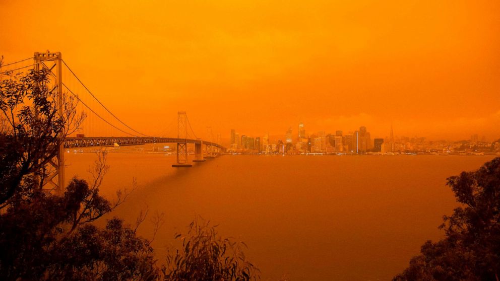 PHOTO: The San Francisco Bay Bridge and city skyline are obscured in orange smoke and haze as their seen from Treasure Island in San Francisco, Calif. on Sept. 9, 2020.