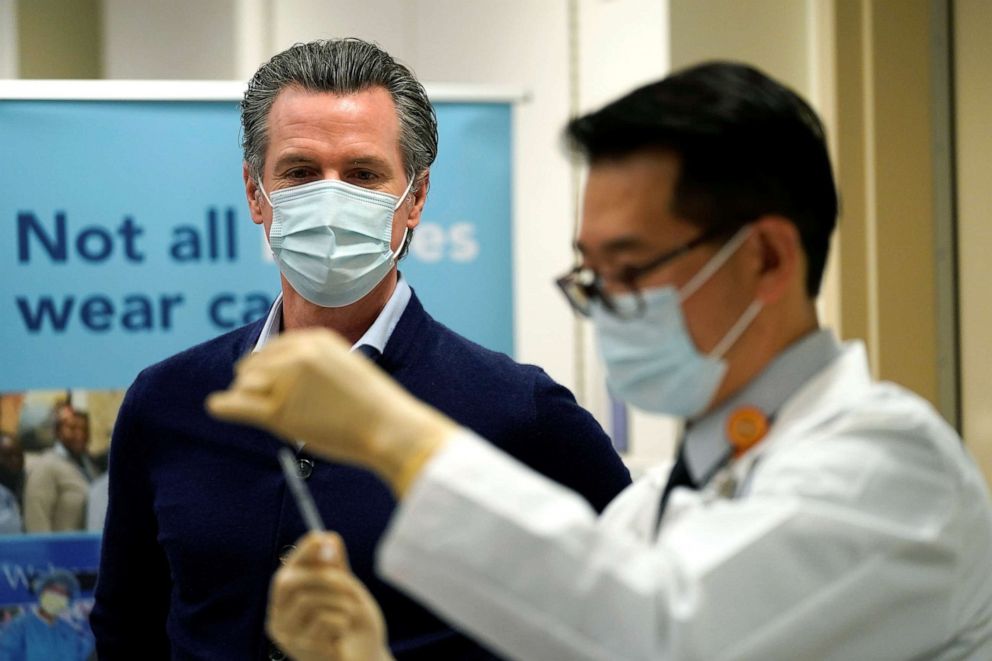 PHOTO: Gov. Gavin Newsom watches as the Pfizer-BioNTech COVID-19 vaccine is prepared by Director of Inpatient Pharmacy David Cheng at Kaiser Permanente Los Angeles Medical Center in Los Angeles, Dec. 14, 2020. 