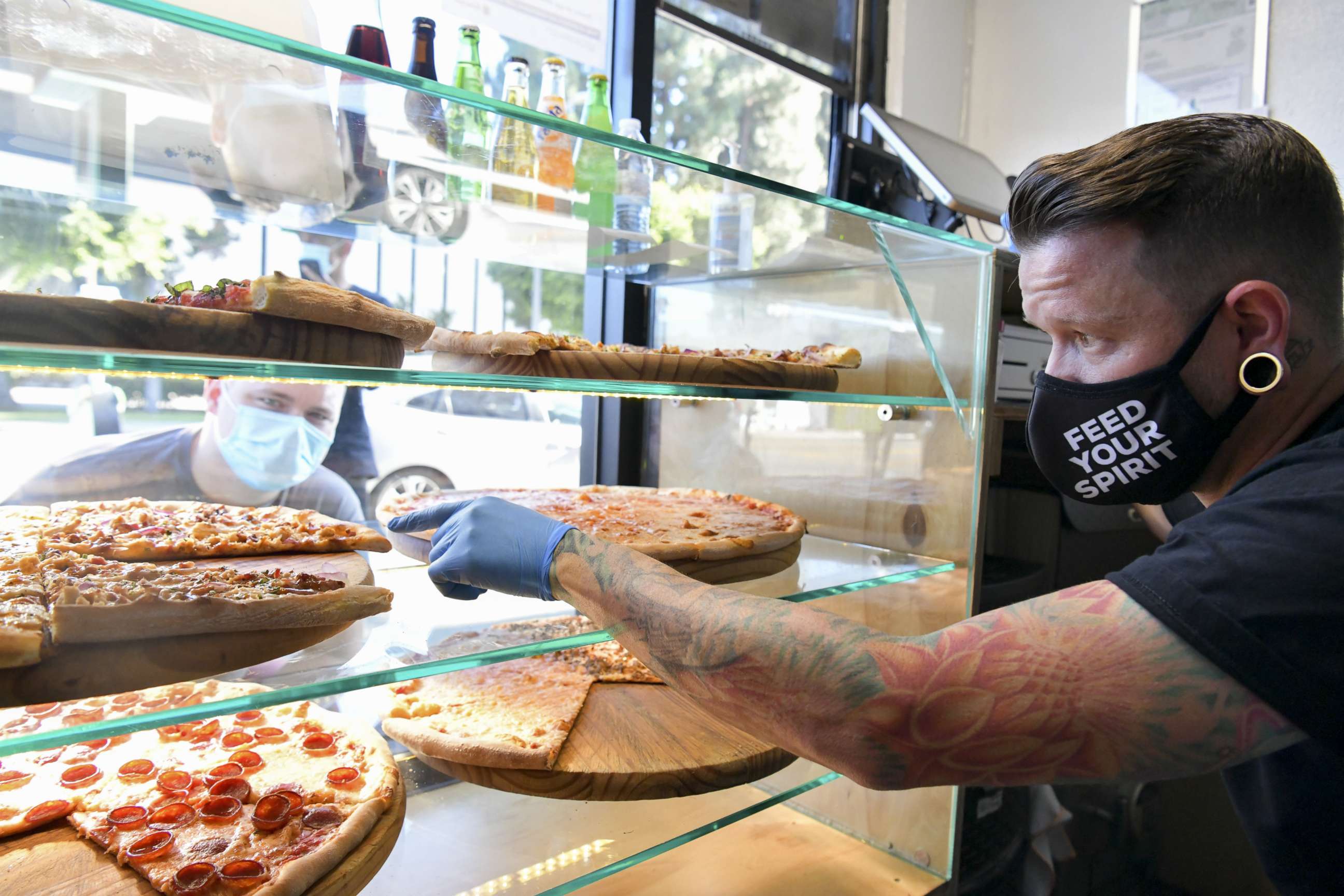 PHOTO: Owner Ben Sales takes orders at Ghost Pizza on July 10, 2020 in Los Angeles.