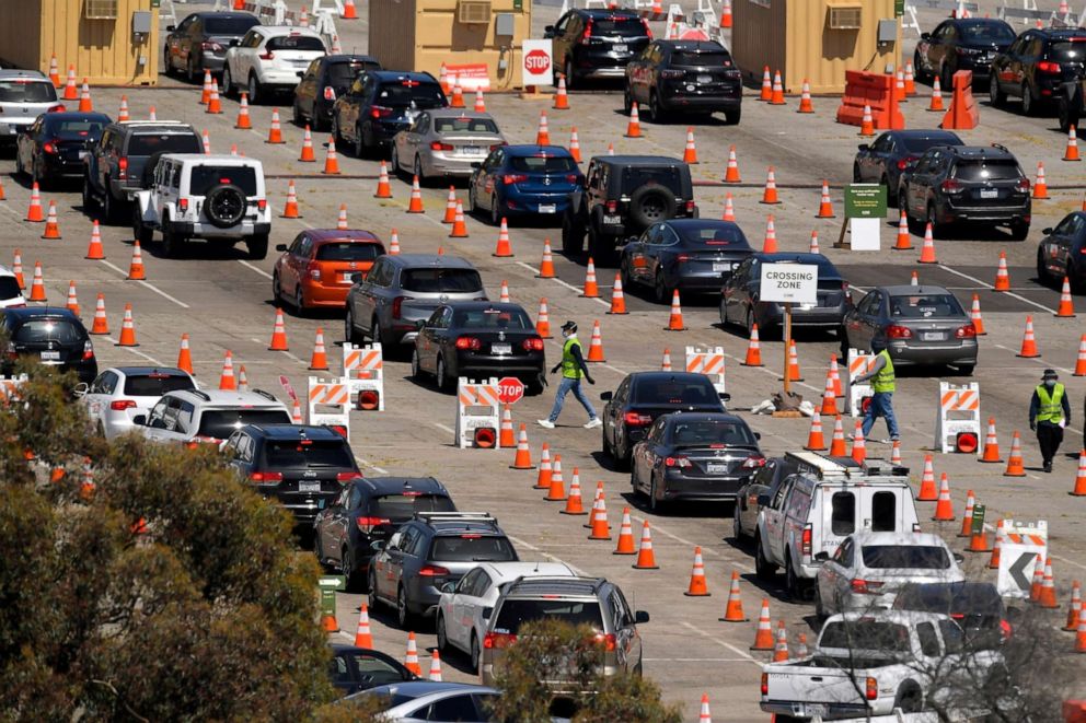 PHOTO: People wait in line for coronavirus testing at Dodger Stadium in Los Angeles, July 14, 2020.