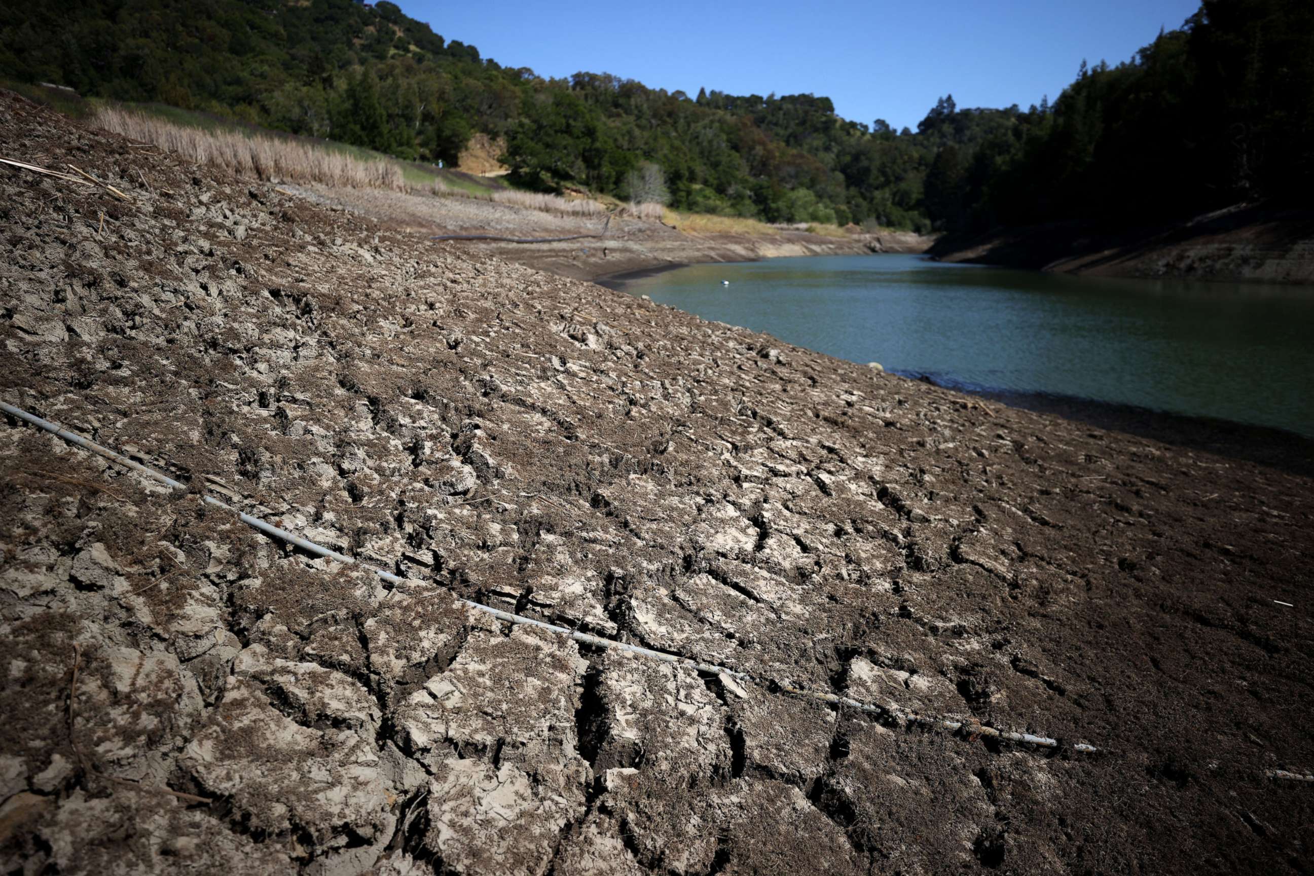 PHOTO: Dry cracked earth is visible along the banks of Phoenix Lake on April 21, 2021, in Ross, Calif.