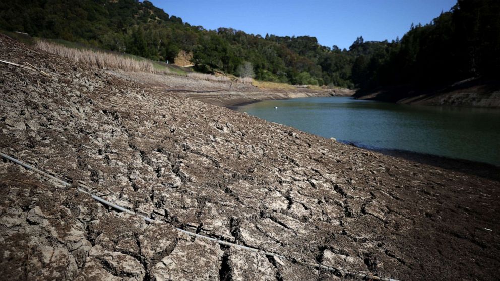 PHOTO: Dry cracked earth is visible along the banks of Phoenix Lake on April 21, 2021, in Ross, Calif.