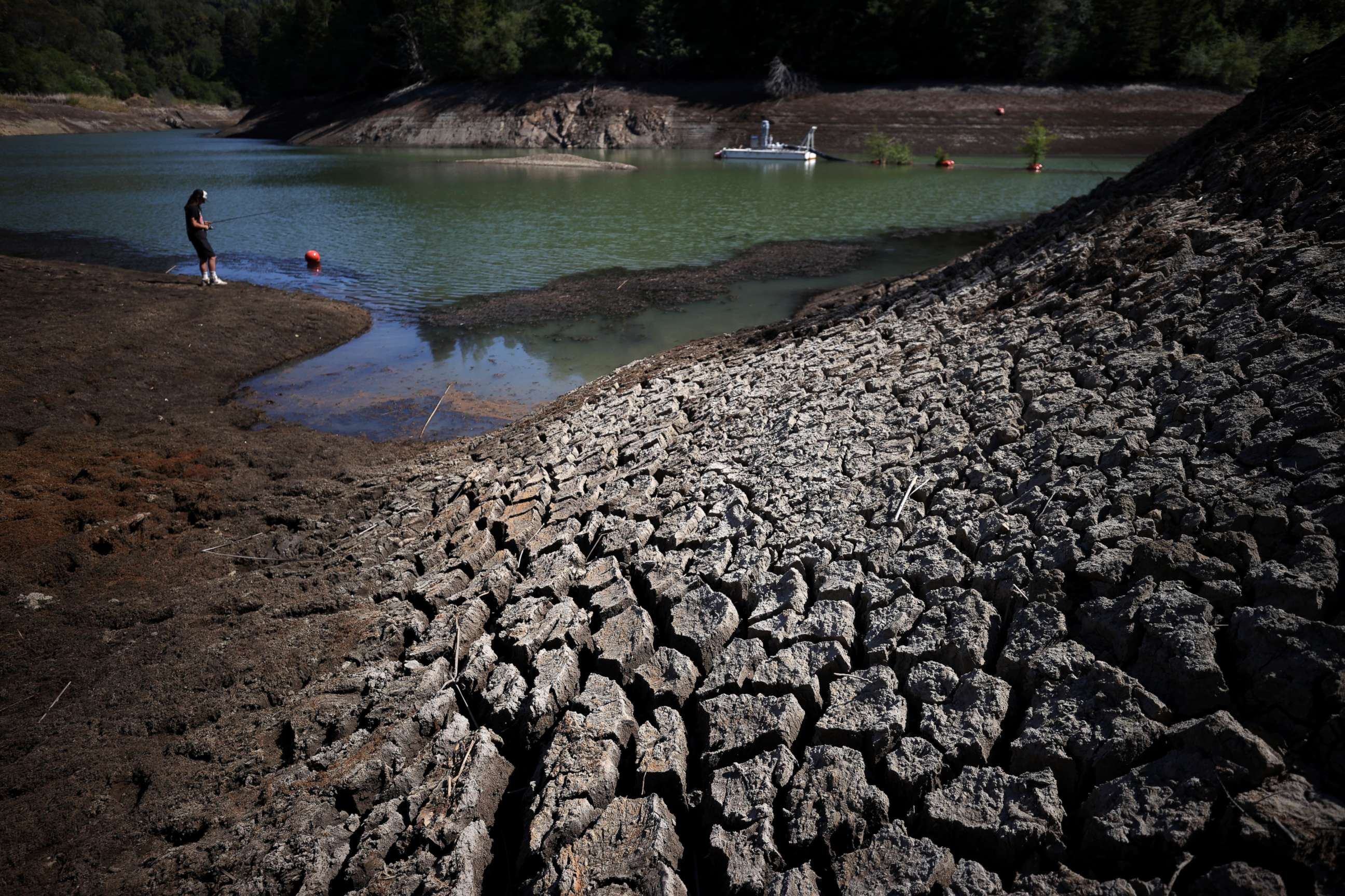 PHOTO: Dry cracked earth is visible along the banks of Phoenix Lake during a new drought emergency on April 21, 2021 in Ross, Calif.