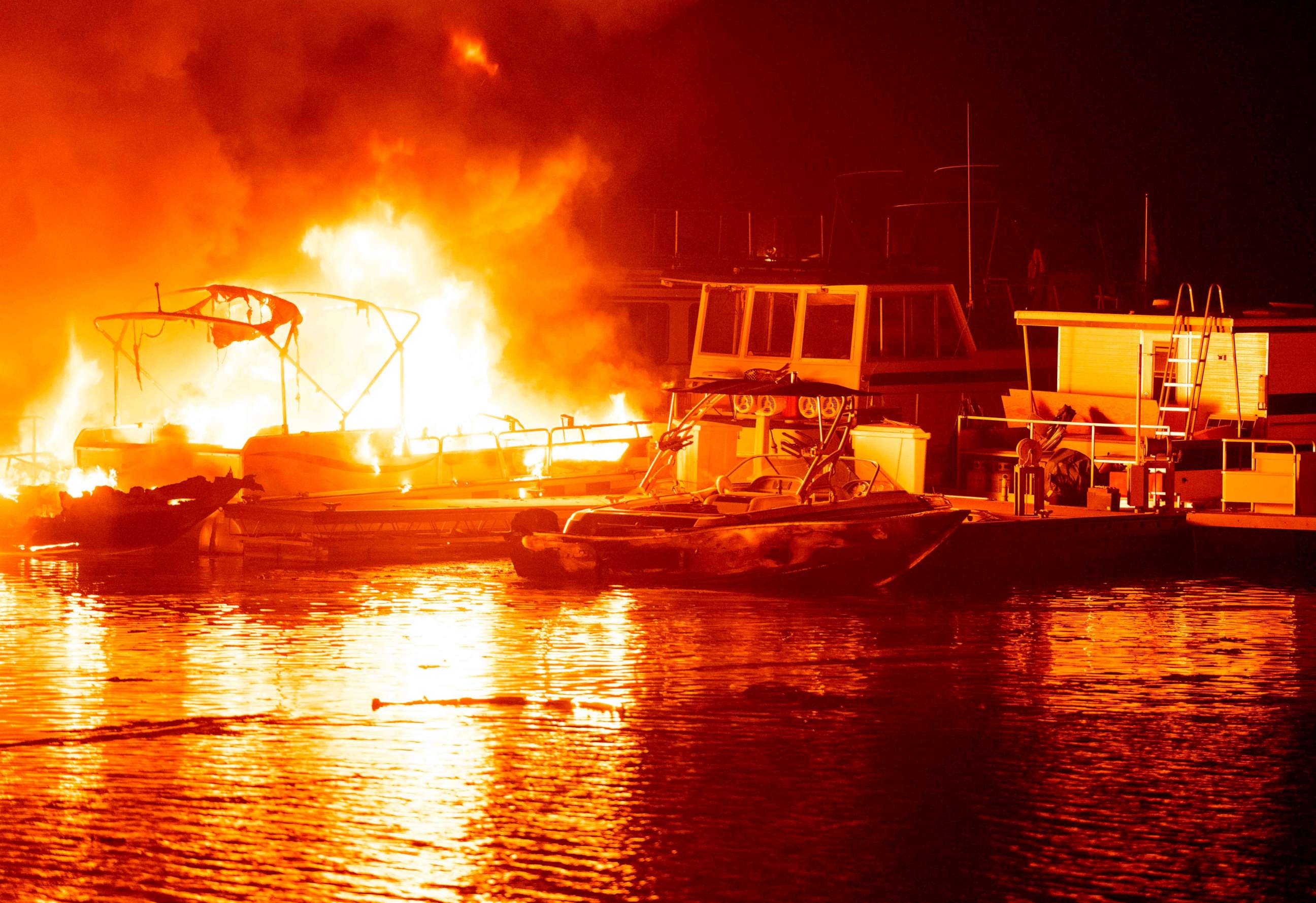 PHOTO: Docked boats burn on Lake Berryessa during the LNU Lightning Complex fire in Napa, California, Aug. 19, 2020.