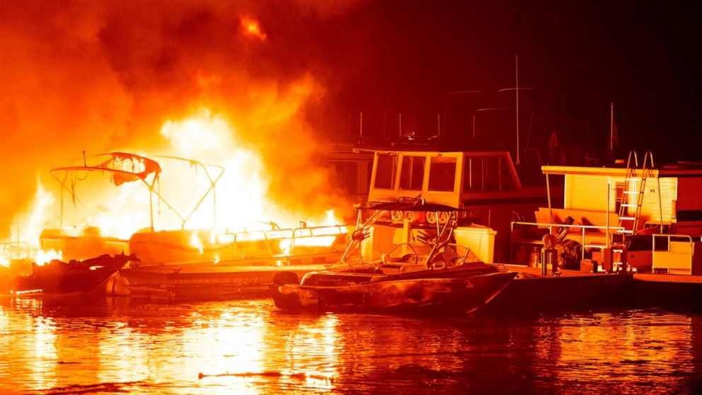 PHOTO: Docked boats burn on Lake Berryessa during the LNU Lightning Complex fire in Napa, California, Aug. 19, 2020.