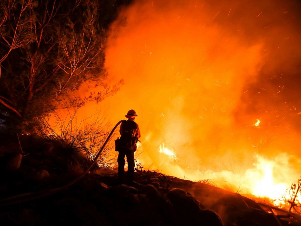 PHOTO: Firefighters battle a wildfire as it burns along a hillside near homes in Santa Paula, Calif., Dec. 5, 2017.