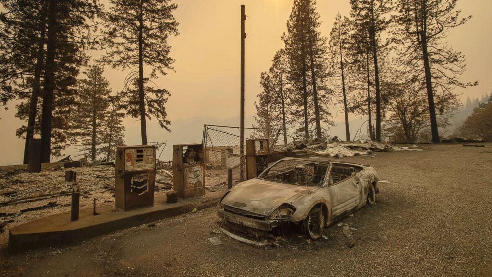 PHOTO: As the Camp Fire burns nearby, a scorched car rests by gas pumps near Pulga, Calif., Nov. 11, 2018.