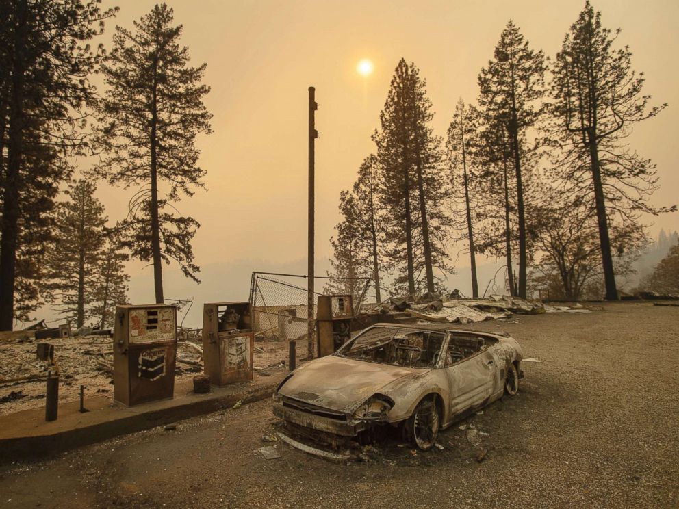 PHOTO: As the Camp Fire burns nearby, a scorched car rests by gas pumps near Pulga, Calif., Nov. 11, 2018.