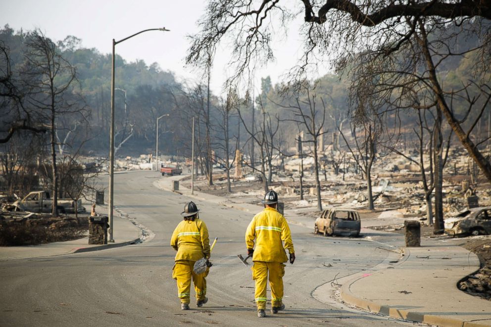 PHOTO: Firefighters walk through the Fountaingrove neighborhood, Oct. 13, 2017, in Santa Rosa, Calif.