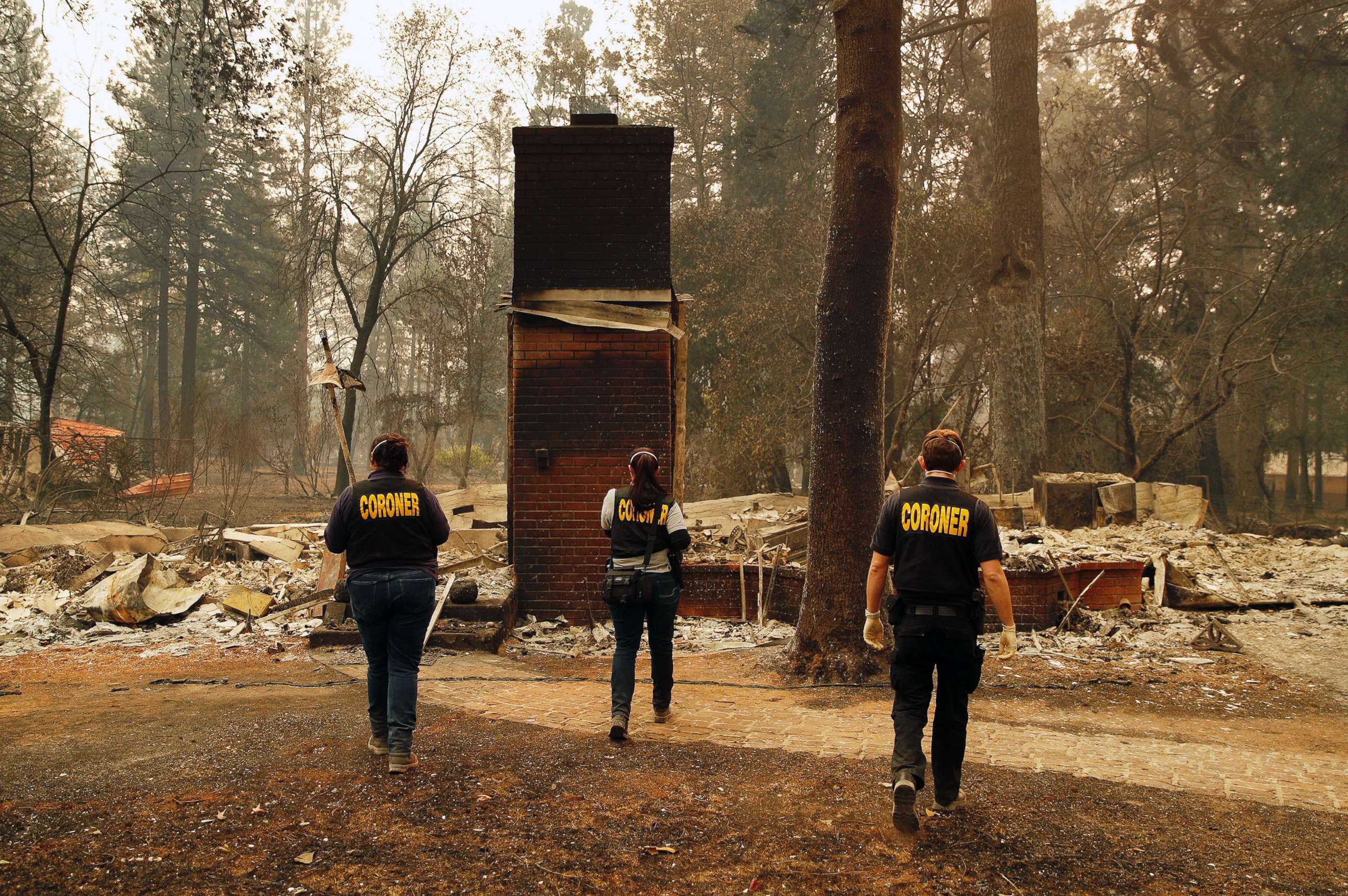 PHOTO: Members of the Sacramento County Coroner's office look for human remains in the rubble of a house burned at the Camp Fire, Nov. 12, 2018, in Paradise, Calif.