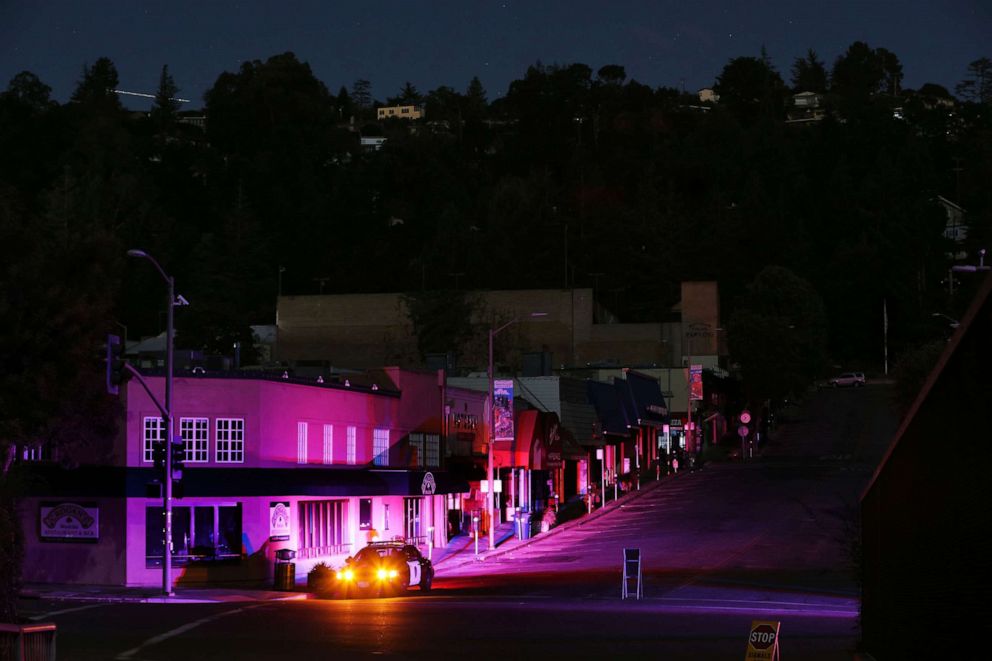 PHOTO: Oakland police officers in a police cruiser stay alert in the Montclair shopping district during the PG&E power outage in Oakland, Calif., on Oct. 10, 2019.