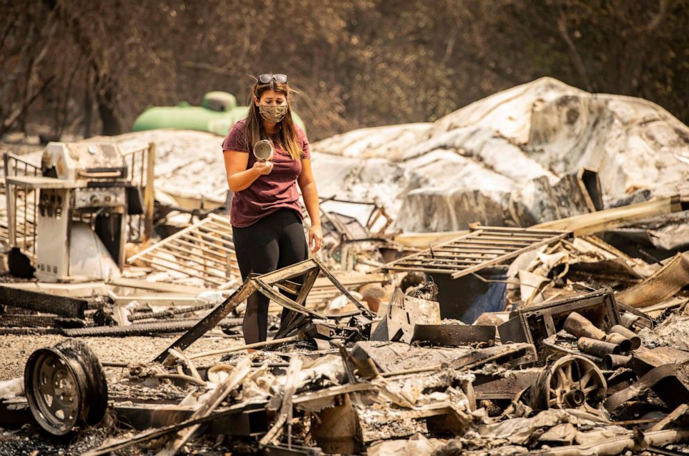 PHOTO: Resident Alyssa Medina reacts after finding an intact cup amidst the burned remains of her home during the LNU Lightning Complex fire in Vacaville, Calif., Aug. 23, 2020.