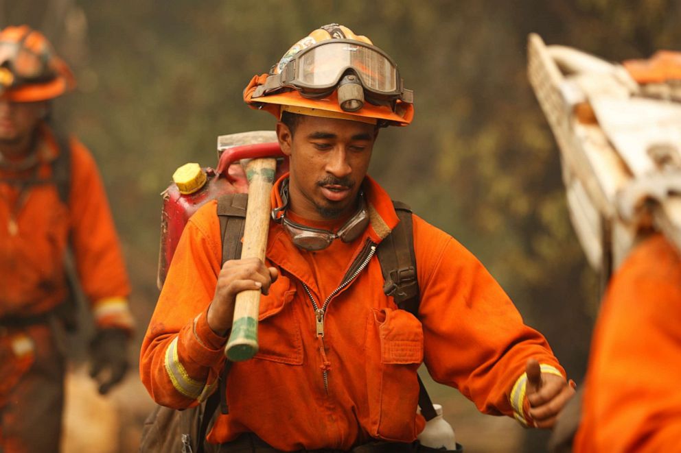 PHOTO: An inmate firefighter marches along State Route 29 during the Glass Fire in Calistoga, California, Oct. 2, 2020.