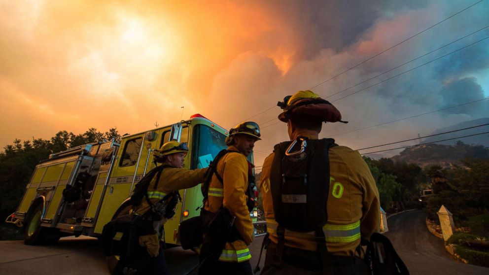 Firefighters from the Governors Office of Emergency Services monitor the advance of smoke and flames from the Thomas Fire, Dec. 16, 2017 in Montecito, Calif.