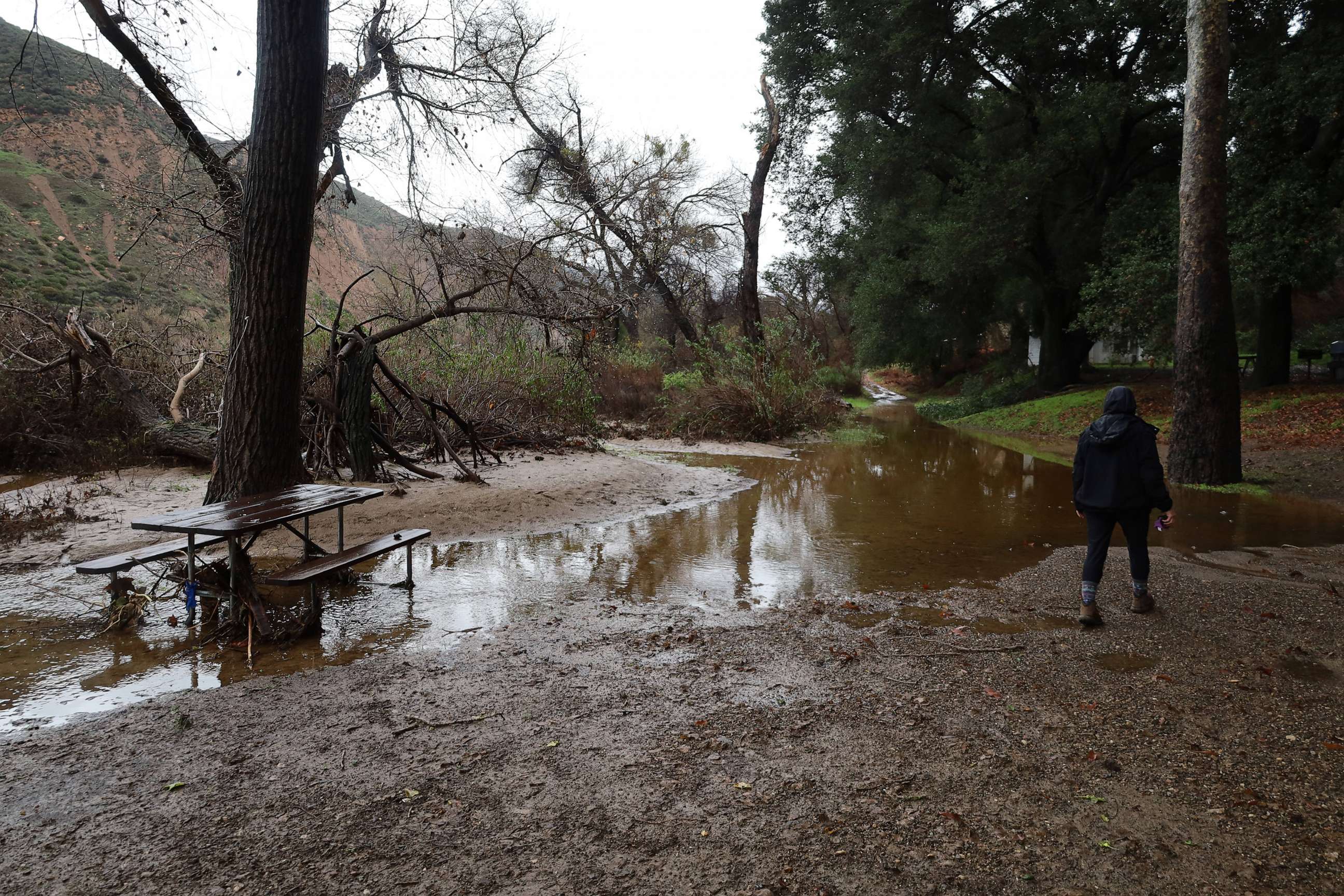 PHOTO: A camper gazes at the destruction at a campsite caused by flash flooding in Los Padres National Forest on Jan. 10, 2023, in Santa Barbara, Calif.