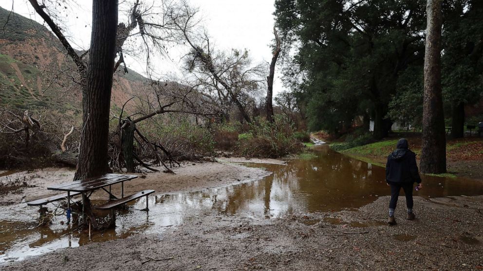 PHOTO: A camper gazes at the destruction at a campsite caused by flash flooding in Los Padres National Forest on Jan. 10, 2023, in Santa Barbara, Calif.