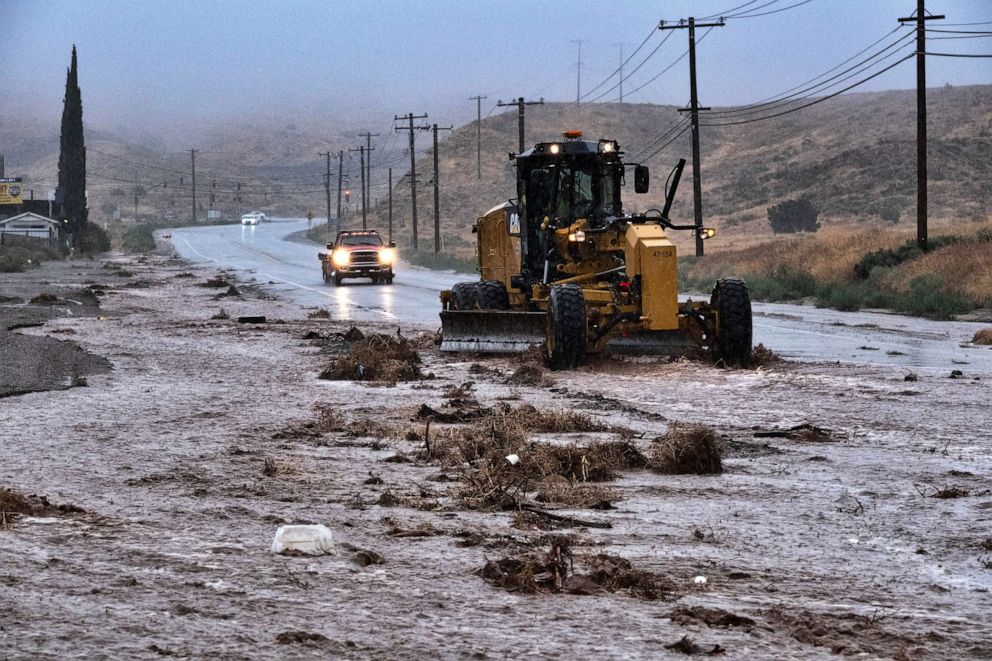 PHOTO: A plow clears debris along a flooded Sierra Highway in Palmdale, Calif., as Tropical Storm Hilary moves through the area on Sunday, Aug. 20, 2023.