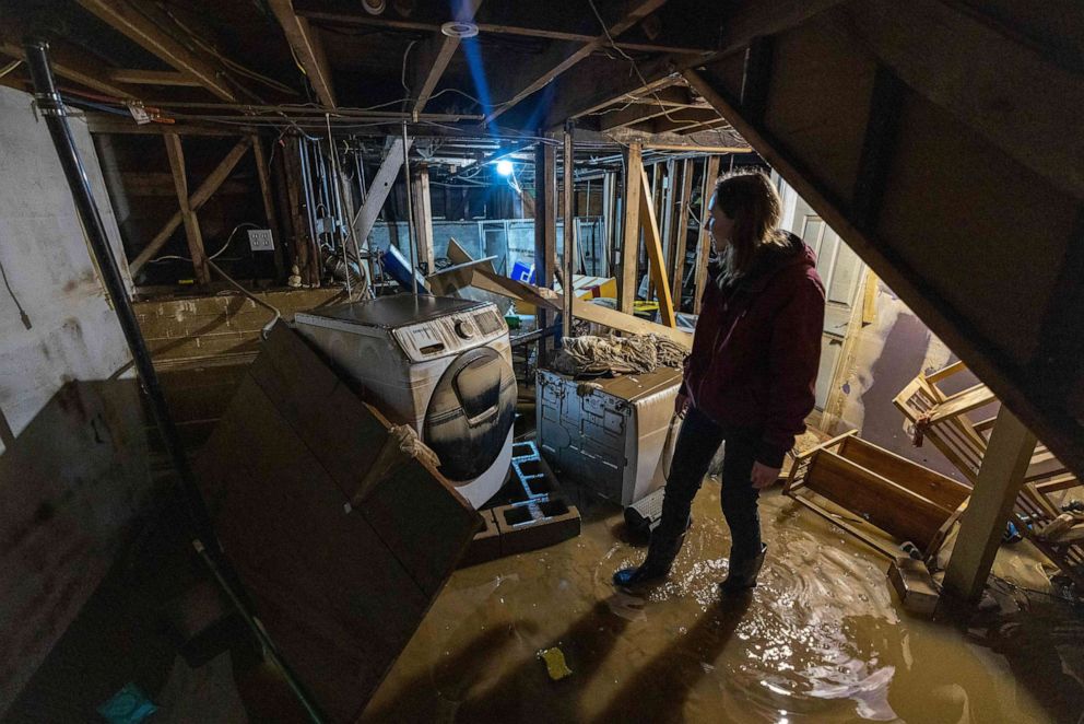 PHOTO: Amberlee Galvin stands in her flooded basement in Felton, California, Jan. 14, 2023, as a series of atmospheric river storms continue to cause widespread destruction across the state.