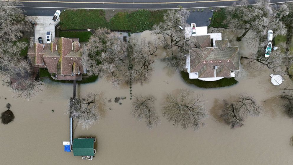 PHOTO: Water from the rainstorm-swollen Sacramento River surrounds homes in West Sacramento, Calif., on Jan. 11, 2023.