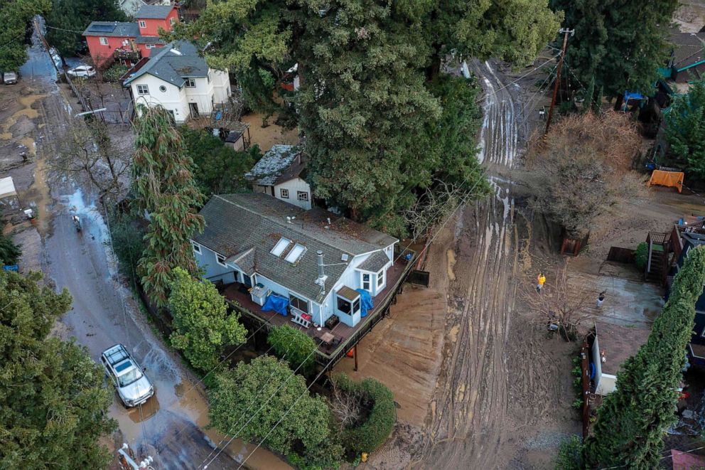 PHOTO: In this aerial picture taken on Jan. 14, 2023, residents clean up their muddy neighborhood in Felton, Calif., as a series of atmospheric river storms continue to cause widespread destruction across the state.