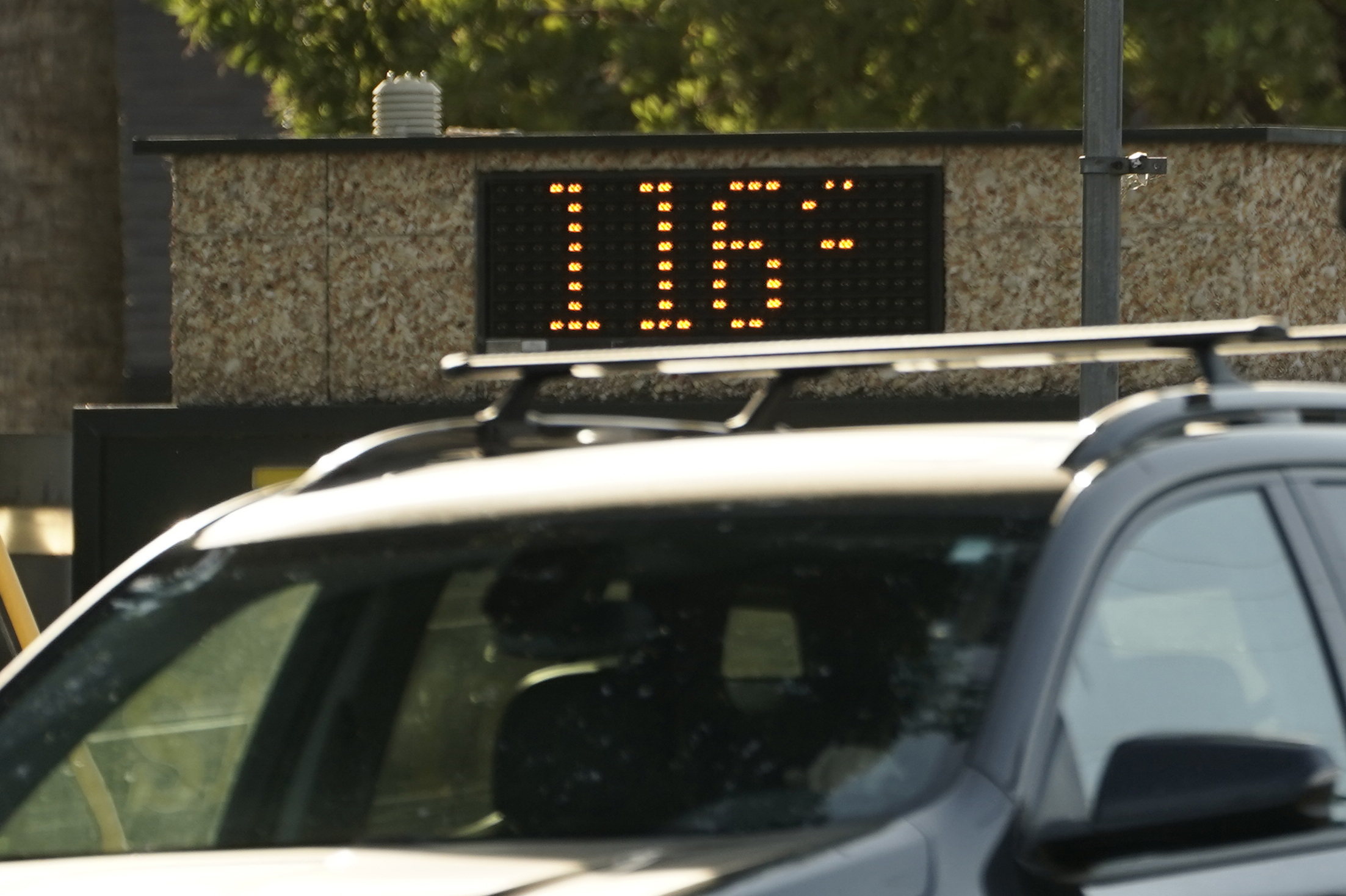 PHOTO: A vehicle passes a bank sign displaying a temperature of 116 degree in Sacramento, Calif., on Sept. 6, 2022.