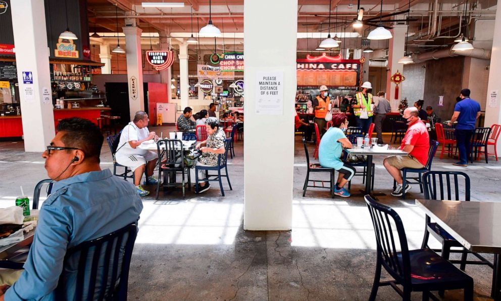PHOTO: People sit at tables at Grand Central Market in downtown Los Angeles, June 24, 2020.