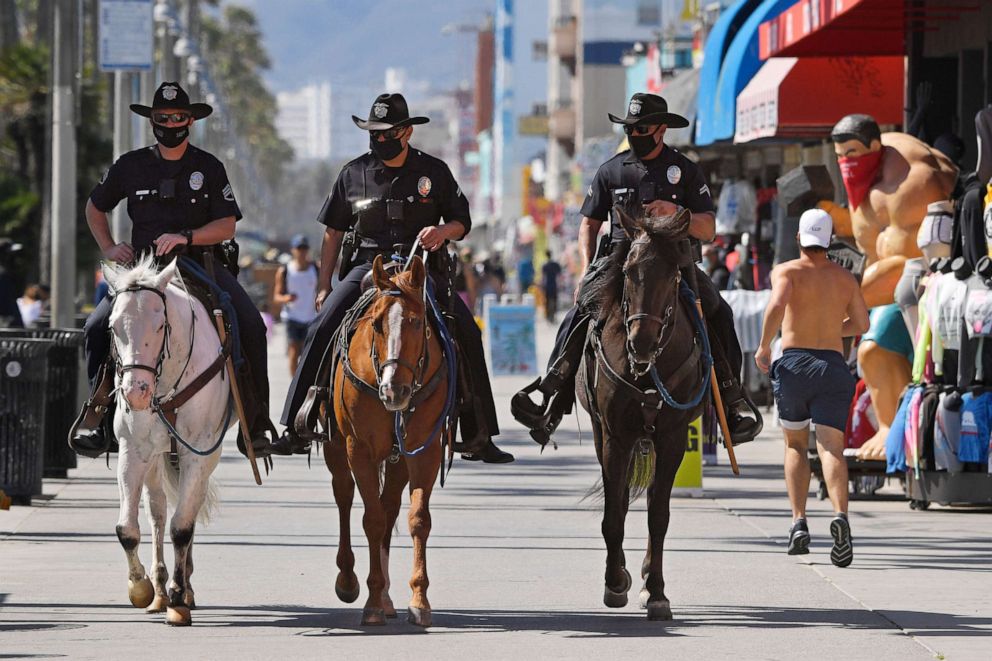 PHOTO: Los Angeles police officers patrol the Venice Beach boardwalk on horseback during the coronavirus outbreak, Wednesday, May 13, 2020, in Los Angeles. 