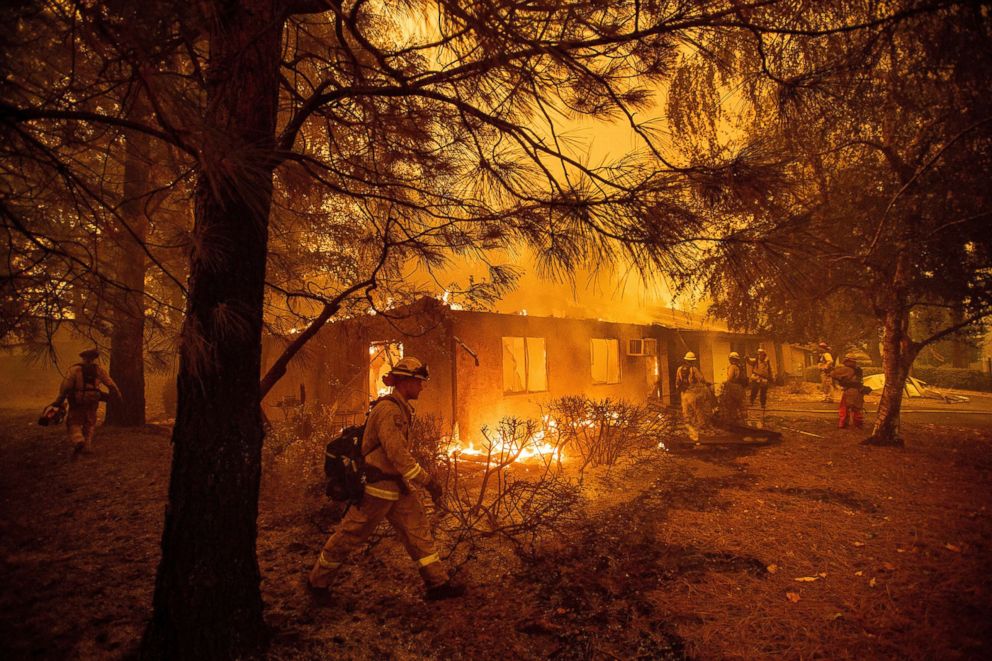 PHOTO: Firefighters work to keep flames from spreading through the Shadowbrook apartment complex as a wildfire burns through Paradise, Calif., Nov. 9, 2018.