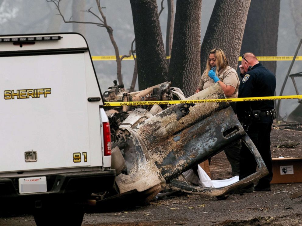 PHOTO: A sheriffs deputy recovers the remains of a Camp Fire victim from an overturned car in Paradise, Calif., Nov. 15, 2018.