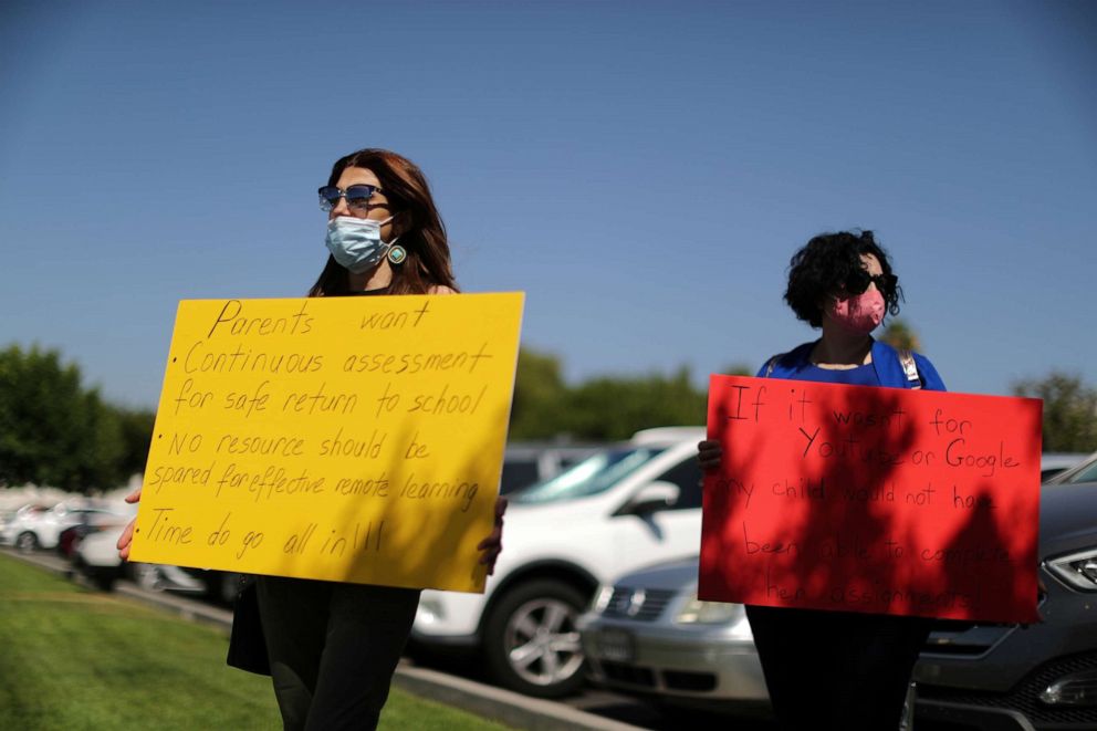 PHOTO: Parents Angelina Hayrapetyan, 38, and Again Nazliyan, 34, participate in a protest highlighting inadequacies in their children's online education outside the Glendale Unified School District Headquarters in Glendale, Calif., July 13, 2020.