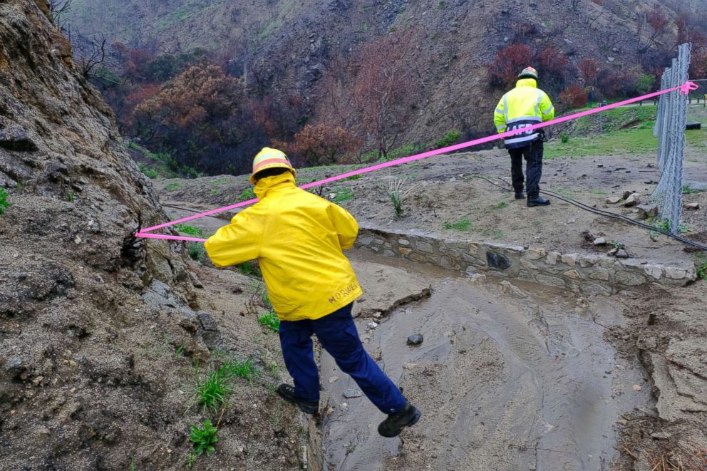 PHOTO: Firefighters close off an area of a mud slide caused by heavy rain along La Tuna Canyon Road in Los Angeles, March 22, 2018, where mandatory evacuation orders had been in place amid moderate to heavy rain.
