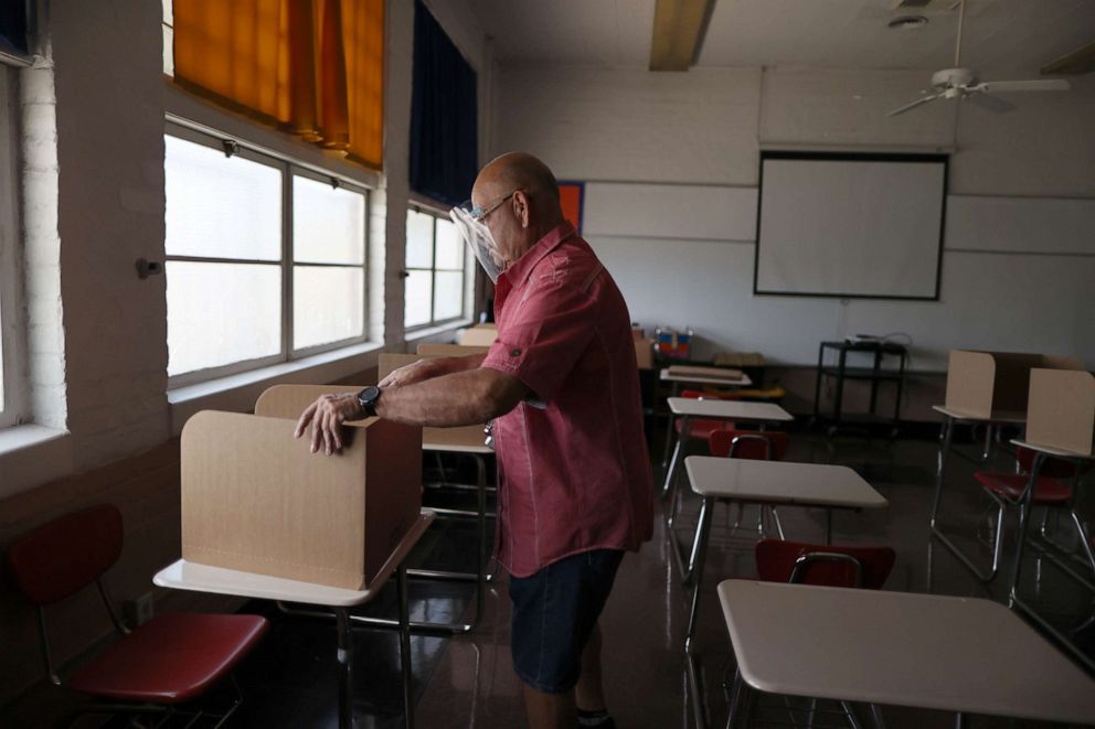 PHOTO: School principal Frank Loya Jr. sets up social distancing dividers for students in a classroom at St. Benedict School, amid the outbreak of the coronavirus disease, in Montebello, Calif., near Los Angeles, on July 14, 2020.