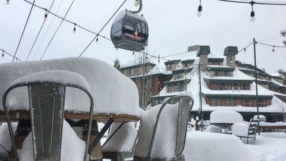 In this photo provided by the Heavenly Mountain Resort, fresh snow covers most of a table and chairs Friday, March 2, 2018, in South Lake Tahoe, Calif. A blizzard warning was in effect for parts of the Sierra Nevada.