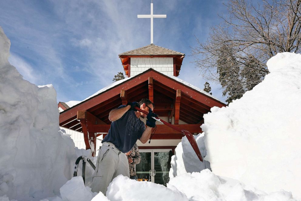 PHOTO: FILE - Residents shovel snow from in front of a church after a series of winter storms dropped more than 100 inches of snow in the San Bernardino Mountains in Southern California, March 8, 2023 in Twin Peaks, Calif.