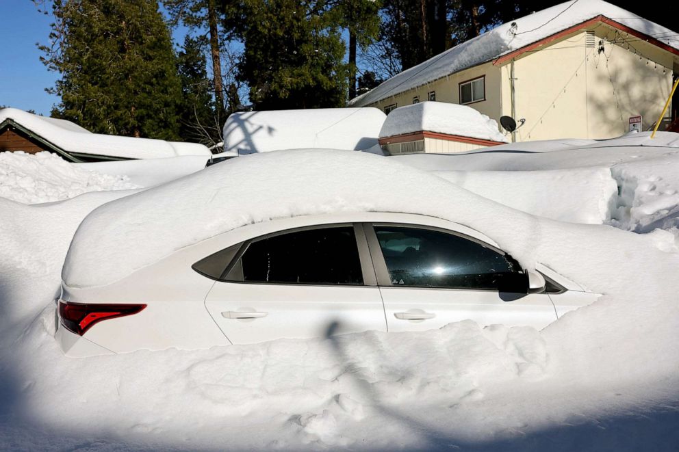 PHOTO: A vehicle is mostly buried in snow after a series of winter storms dumped heavy snowfall in the San Bernardino Mountains in Southern California, March 3, 2023 in Crestline, Calif.
