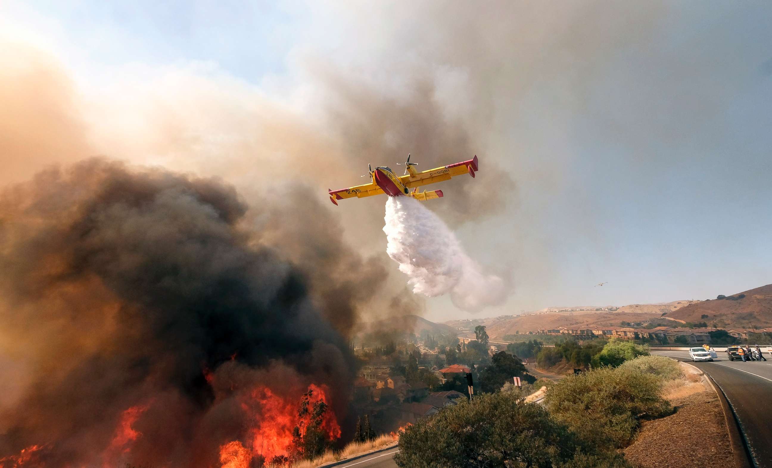 PHOTO: An air tanker drops water on a fire along the Ronald Reagan (118) Freeway in Simi Valley, Calif., Nov. 12, 2018.