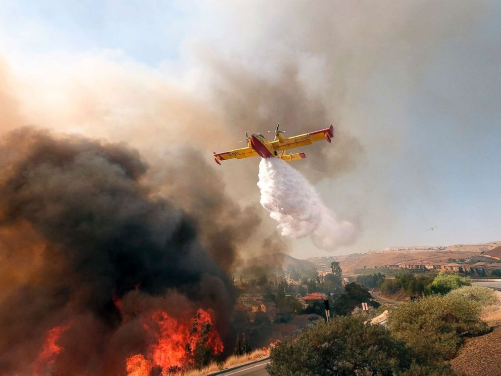 PHOTO: An air tanker drops water on a fire along the Ronald Reagan (118) Freeway in Simi Valley, Calif., Nov. 12, 2018.