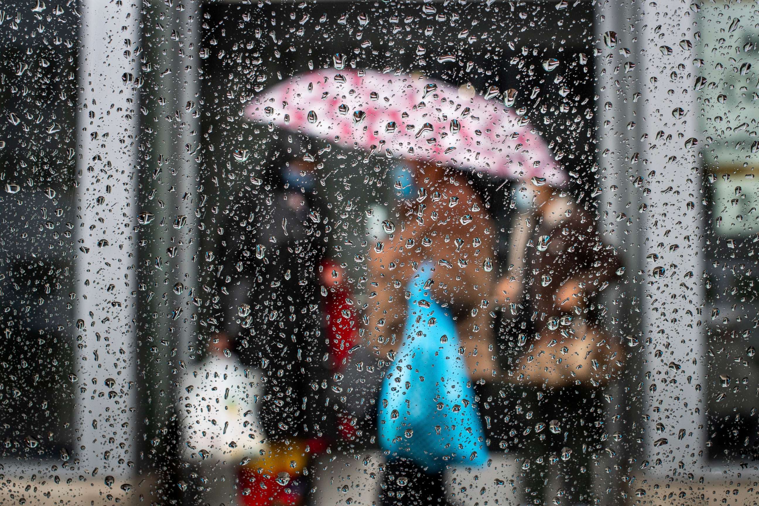 PHOTO: Women try to stay dry on Western Avenue as a much needed rain lands in Los Angeles, Wednesday, March 3, 2021.
