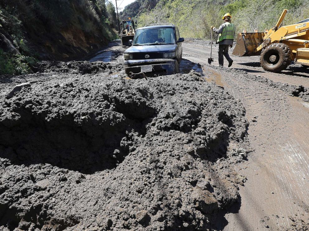 PHOTO: Workers prepare to free a trapped car from tons of debris after mudslides from heavy rain overnight caused the closure of Topanga Canyon Boulevard in Malibu, Calif., March 15, 2018.
