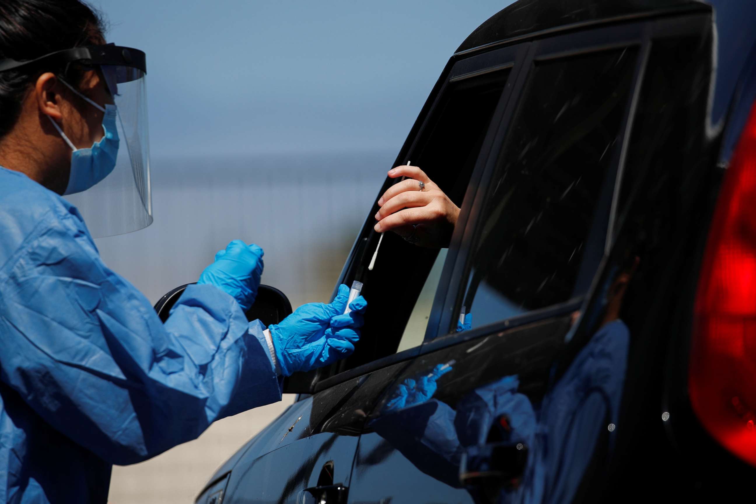 PHOTO: A San Diego county nurse works at a newly opened drive through testing site at a closed high school in Imperial Beach, Calif., July 16, 2020.
