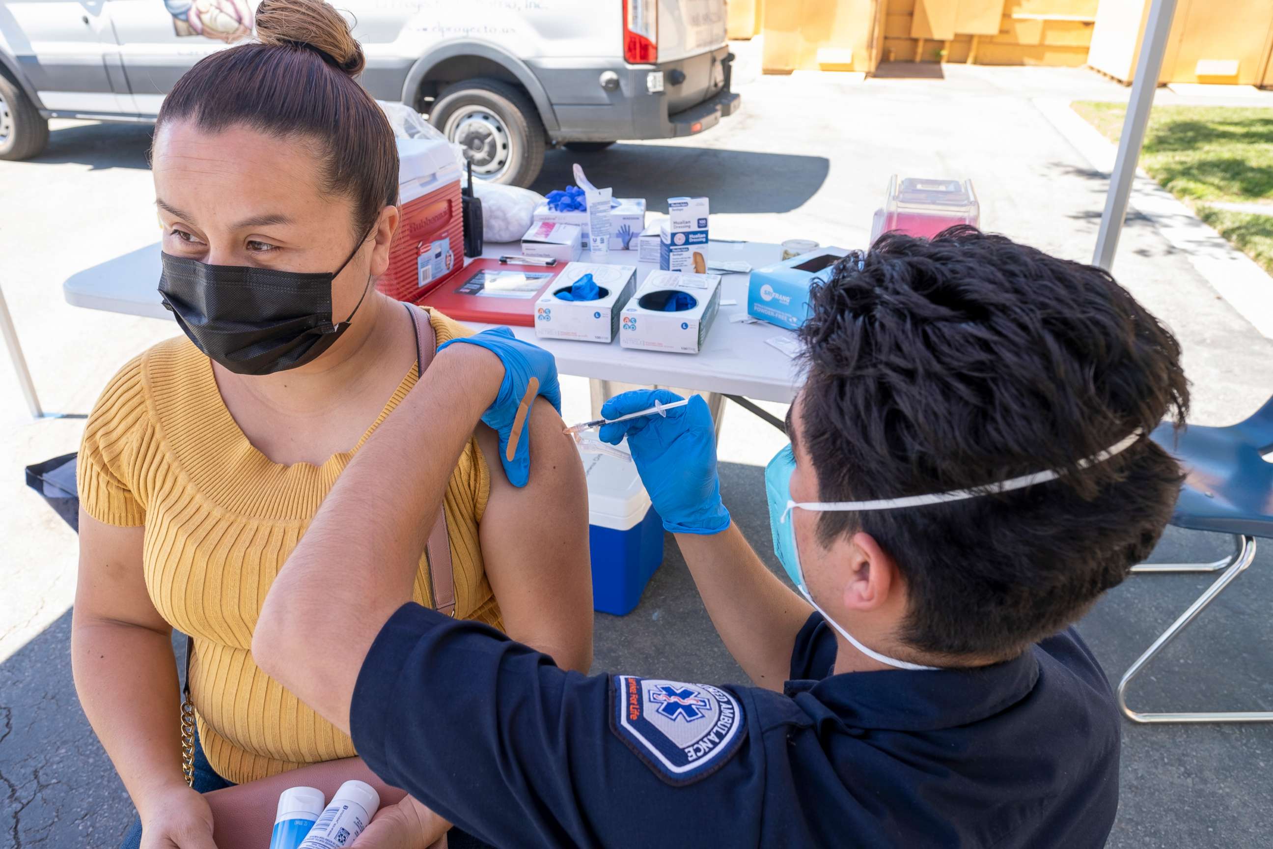 PHOTO: A woman gets a COVID-19 vaccination from an EMT at a Medi-Vaxx Program of the San Fernando Valley pop up clinic at the Montague Charter Academy in Arleta, Calif., Aug. 2, 2021.