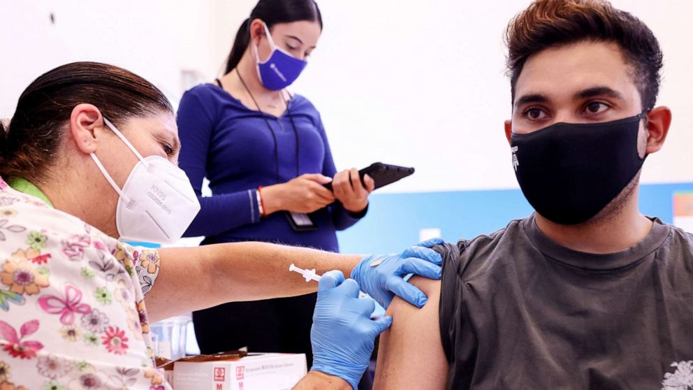 PHOTO: A nurse administers a dose of the Pfizer COVID-19 vaccine as a community health worker monitors, at a three-day vaccination clinic at Providence Wilmington Wellness and Activity Center on July 29, 2021, in Wilmington, Calif.