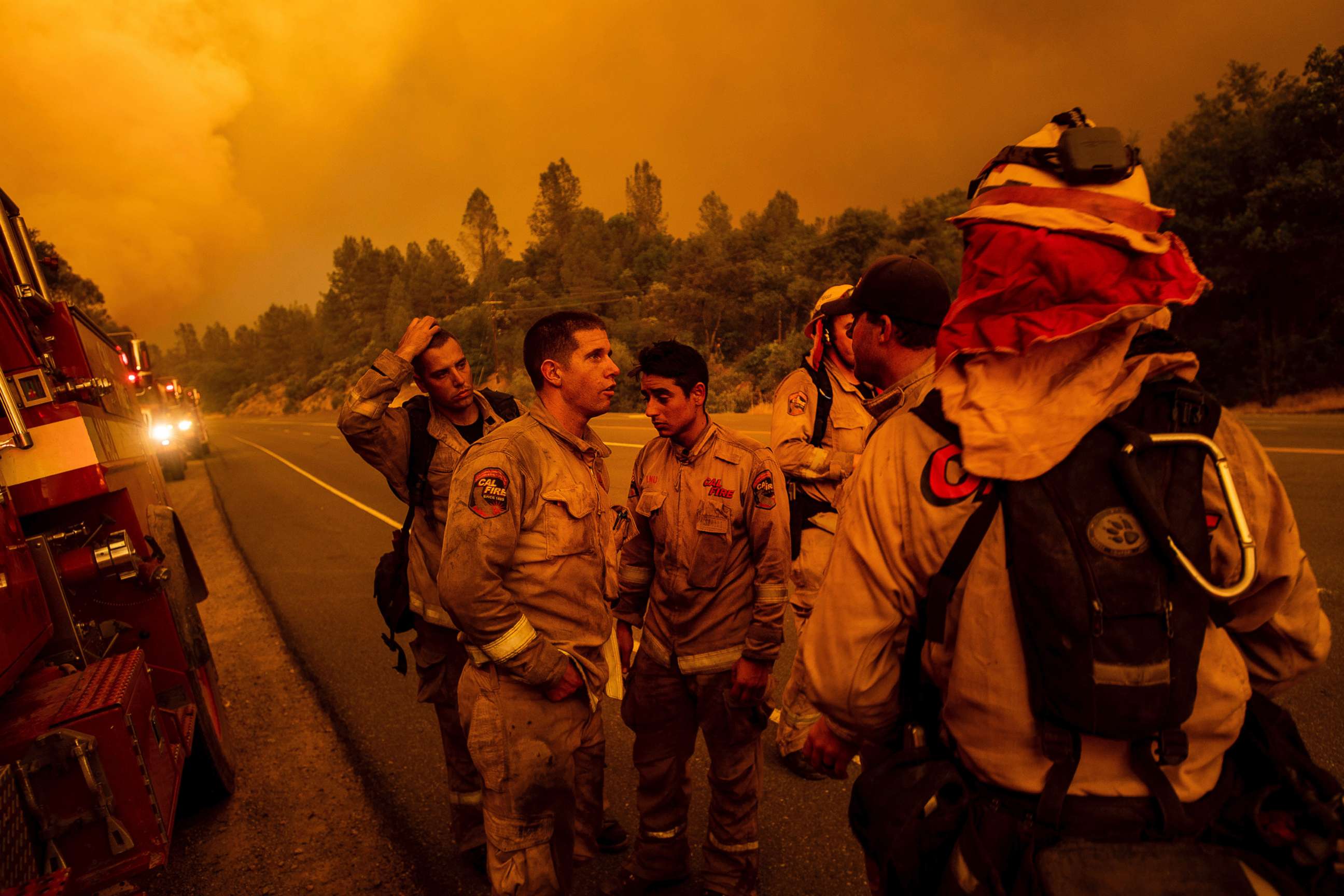 PHOTO: Firefighters discuss plans while battling the Carr Fire in Shasta, Calif., on Thursday, July 26, 2018.
