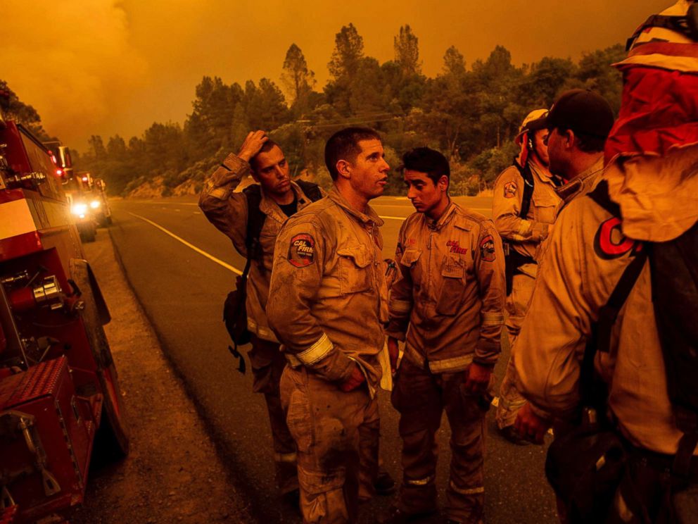 PHOTO: Firefighters discuss plans while battling the Carr Fire in Shasta, Calif., on Thursday, July 26, 2018.