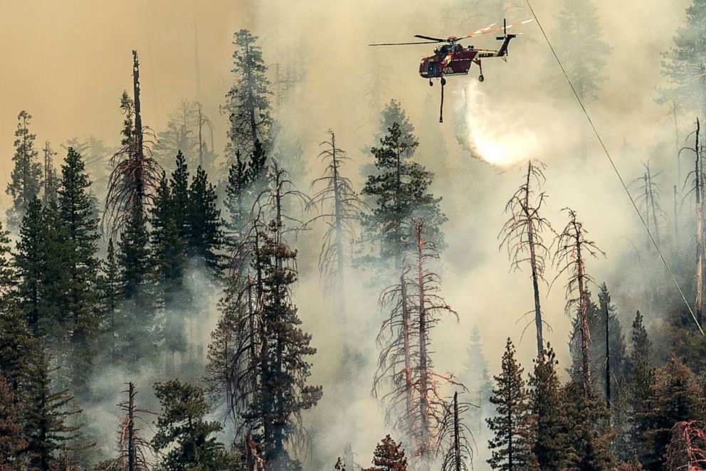 PHOTO: A helicopter drops water on the Washburn Fire burning in Yosemite National Park, July 9, 2022. 
